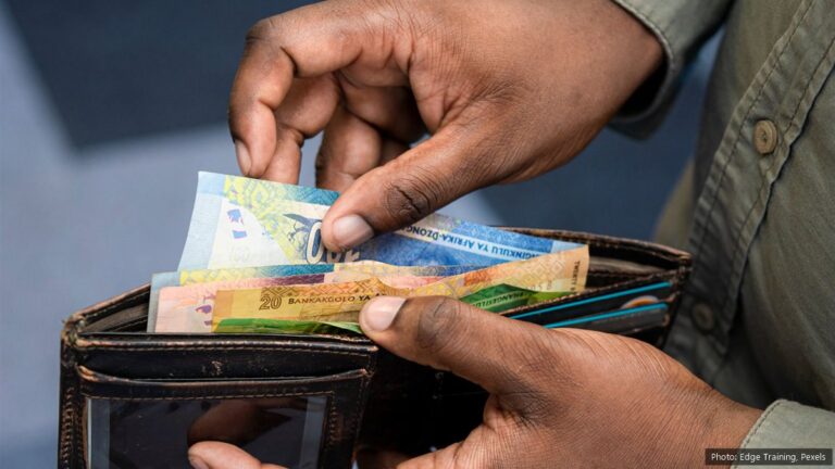 Inflation Rate South Africa: September 2026 CPI Is 4.5% Hands taking South African rand banknotes, including R20 and R100 notes, out of a leather wallet
